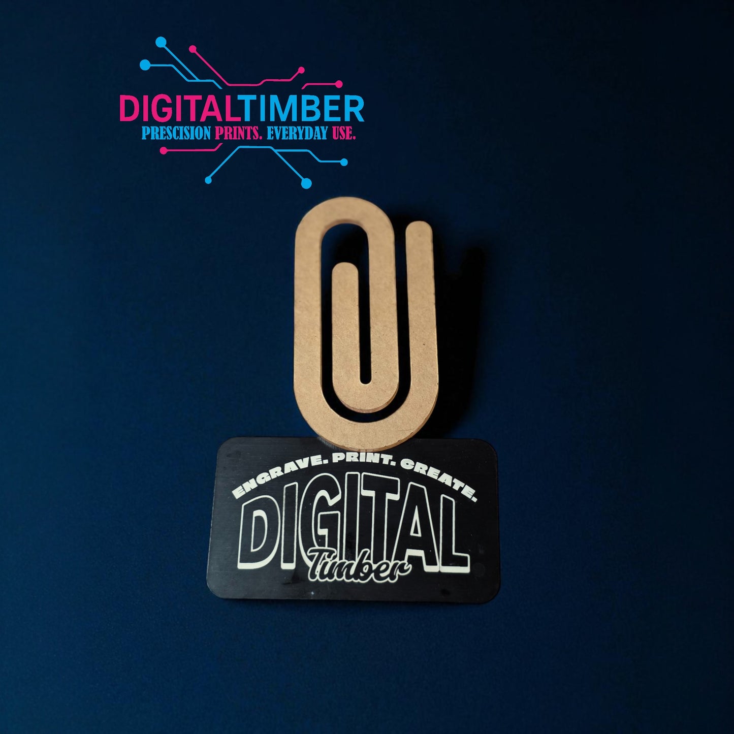 Wooden paper clip with 'Digital Timber' branding on a dark blue background