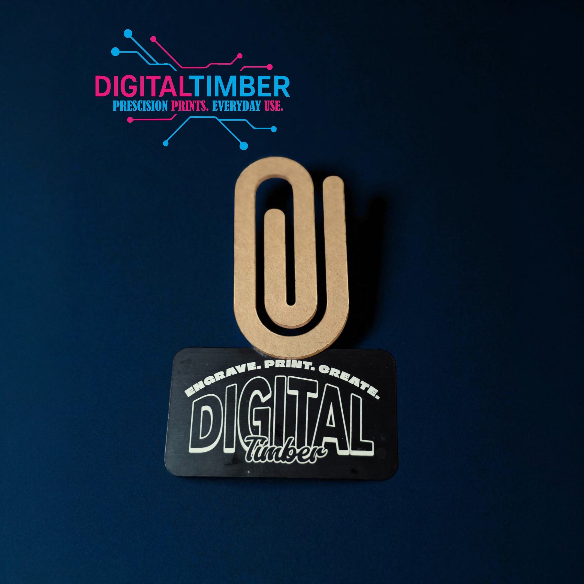 Wooden paper clip with 'Digital Timber' branding on a dark blue background
