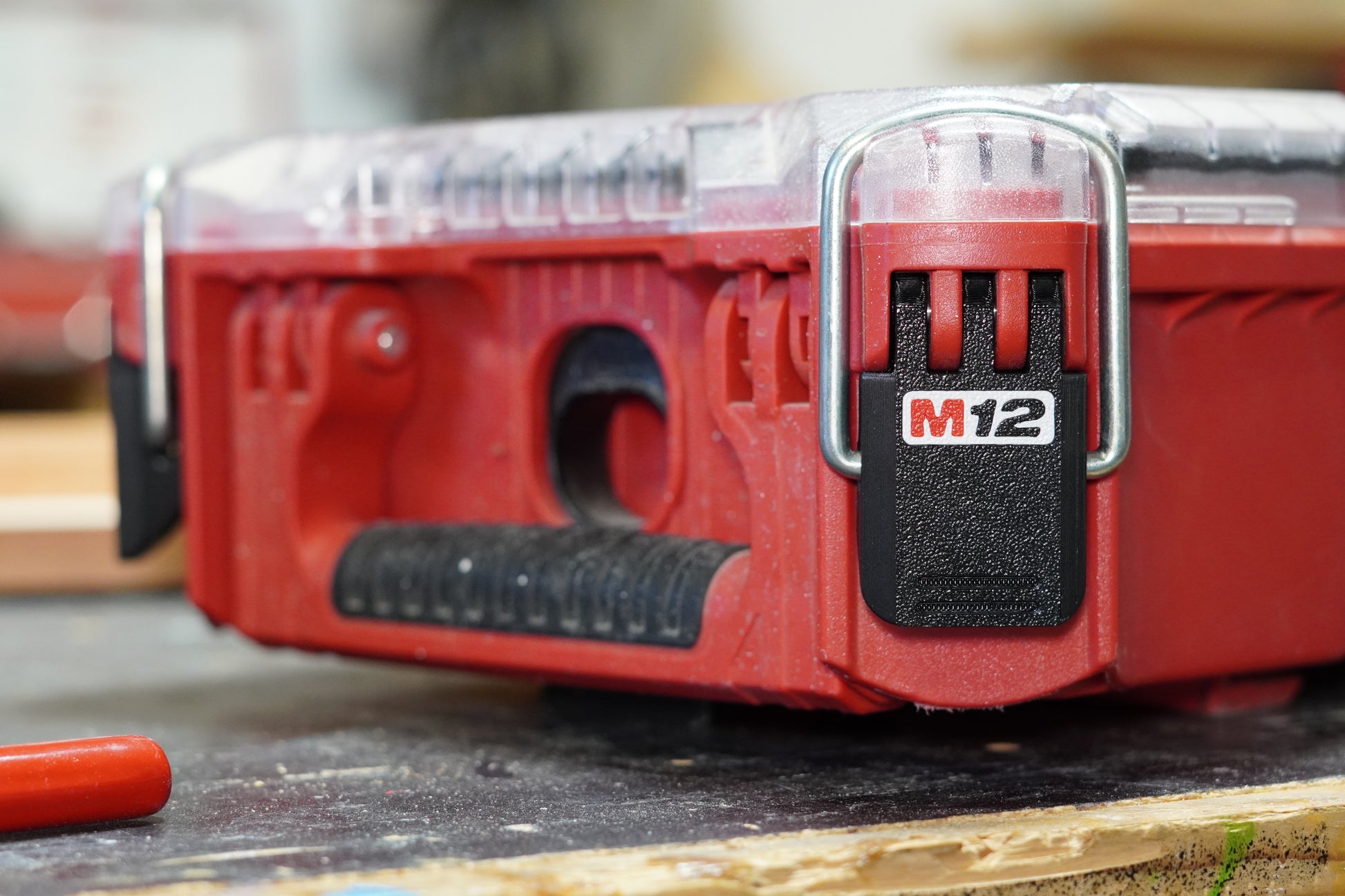 Installed on red Packout box (close) – "Milwaukee M12 latch installed on Packout 48-22-8435