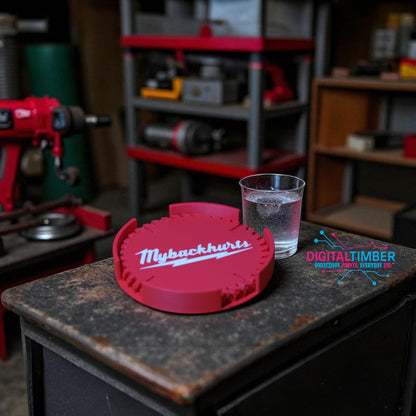 Red tool with 'MyBackhurts' branding on a workbench with a glass of water.