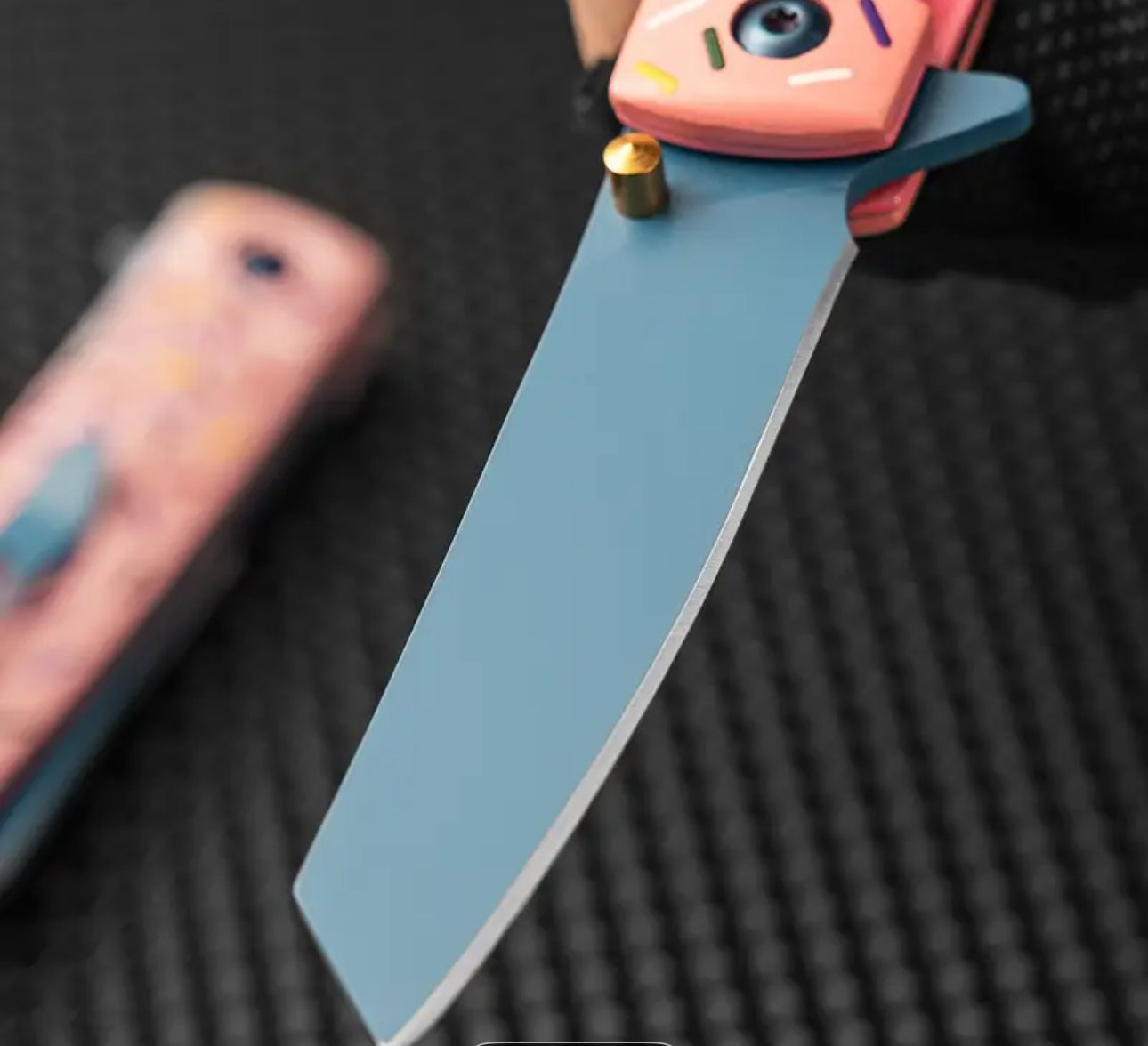 Close-up of Sprinkle Donut Knife’s blue stainless steel blade showing detail and sharpness
